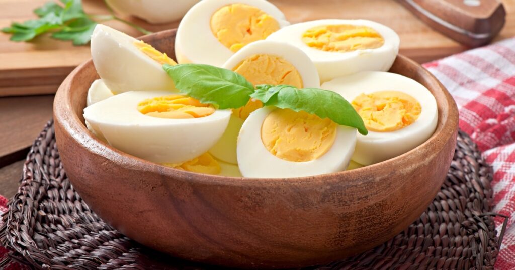 Boiled eggs in a bowl decorated with parsley leaves