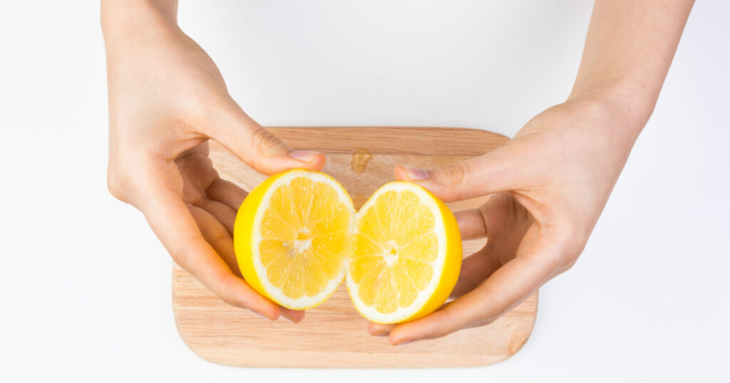 Holding Sliced Lemon