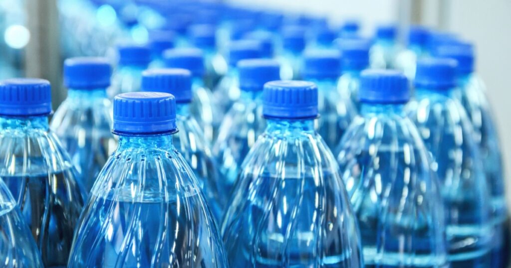 Closeup on mineral water bottles in raw and lines
