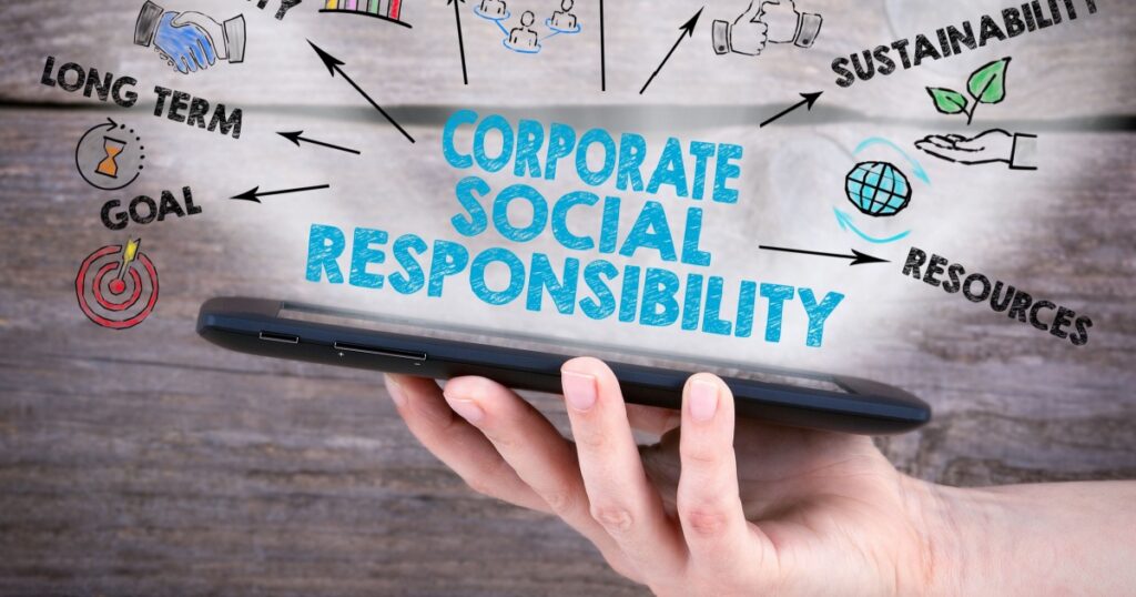 Corporate Social Responsibility Concept. Tablet computer in the hand. Old wooden background