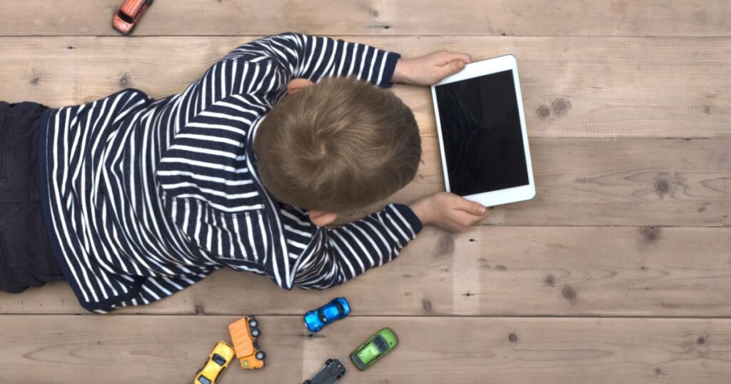 Modern generation. Kid playing on ipad