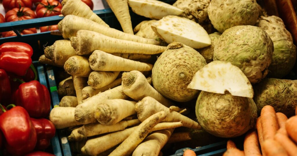 Basket with horseradish, radish, tomato, pepper, carrots on the farm market. Natural local products on the farm market. Harvest. Seasonal products. Food.