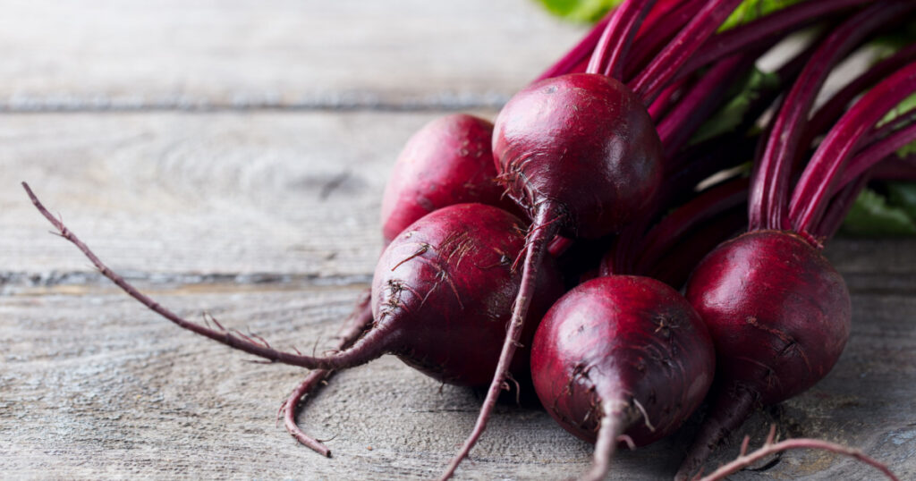 Fresh organic beet, beetroot. Grey rustic wooden background. Close up.