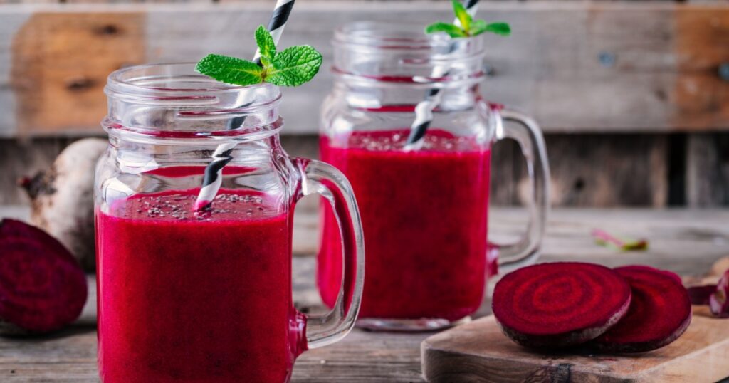 healthy detox beet smoothie with chia seeds in a mason jar on a wooden background