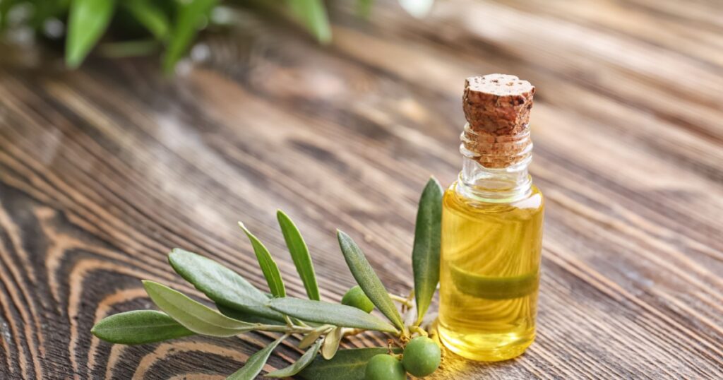 Bottle with olive oil on wooden table