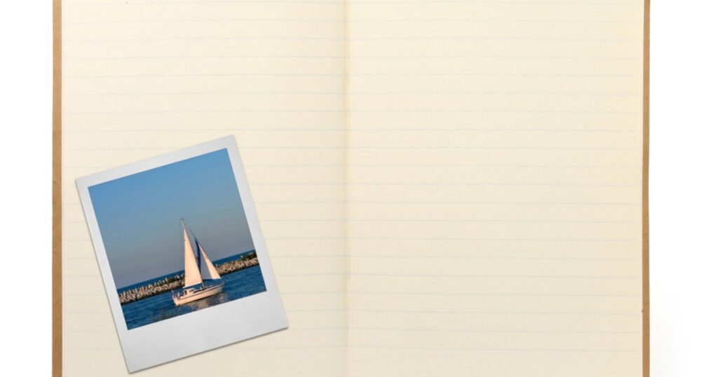 blank lined exercise book and photo frame, gentle shadow in front, photo inside is my property,