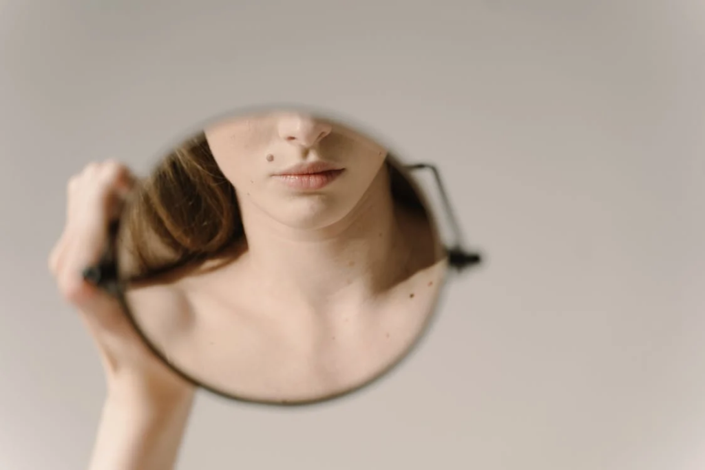 woman looking in mirror