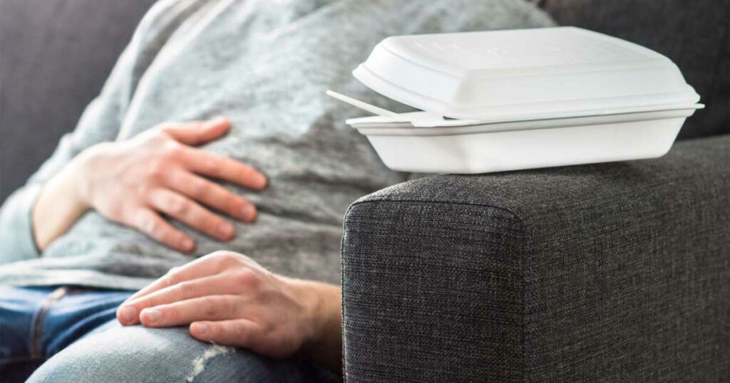man holding stomach