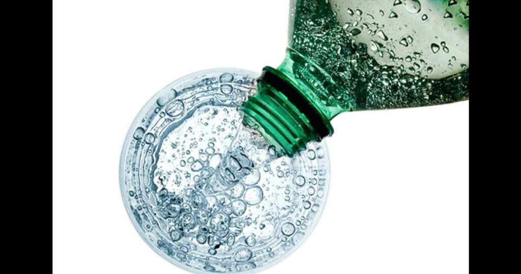 Soda water pouring, top view on white background
