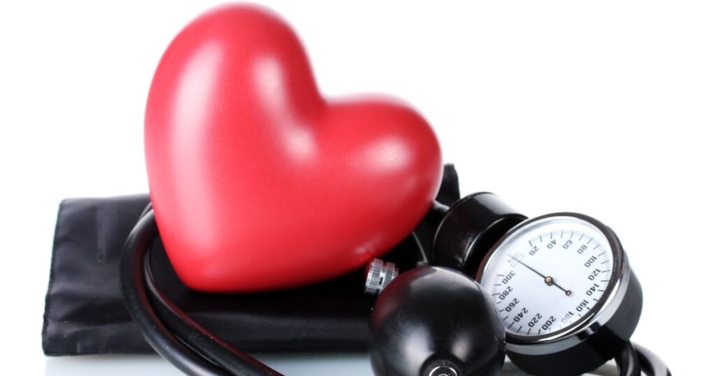 Black tonometer and heart isolated on white