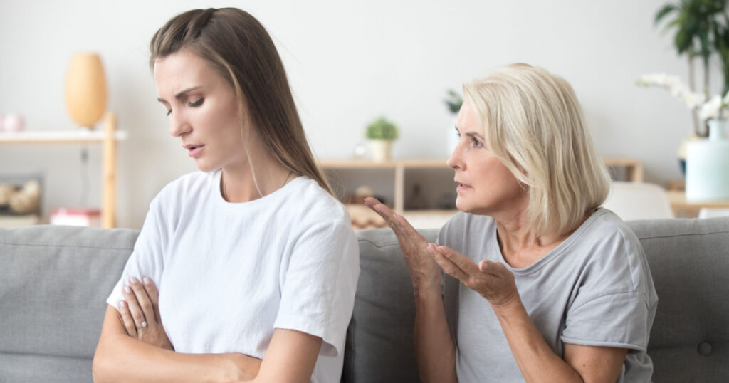 Upset adult daughter ignoring not listening to senior old strict mother in law arguing moralizing scolding controlling showing authority to stubborn young woman, different generation conflict concept