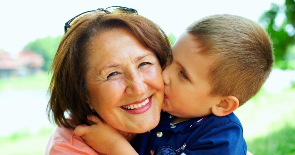 happy grandma with grandson embracing outdoor