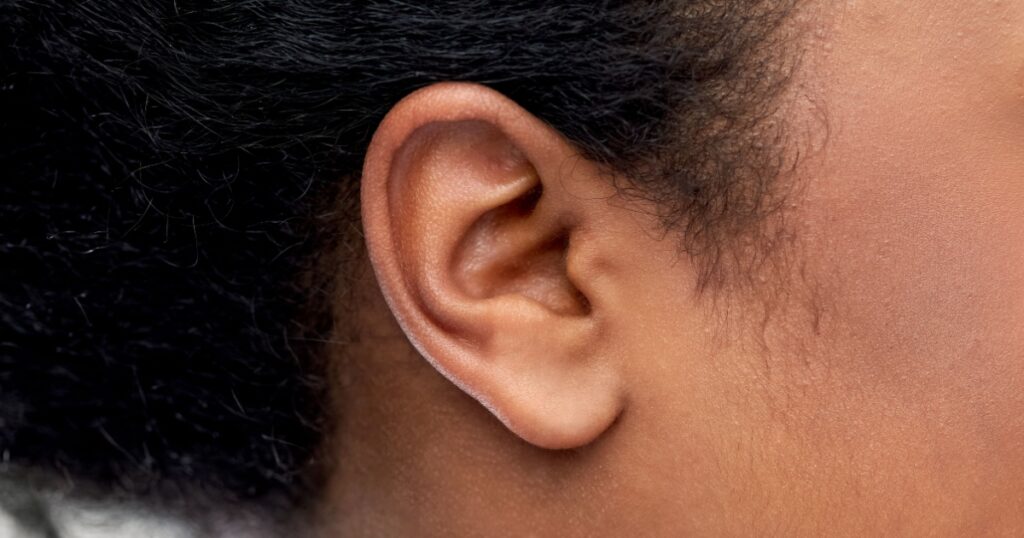 health, people and hearing concept - close up of young african american woman ear