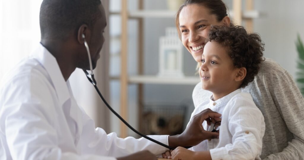 African male pediatrician hold stethoscope exam child boy patient visit doctor with mother, black paediatrician check heart lungs of kid do pediatric checkup in hospital children medical care concept
