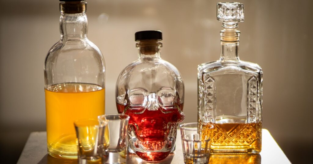 Set of bottles with home made tasty liqueurs inside.