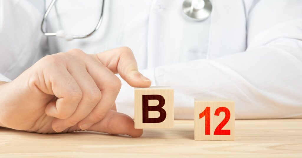 essential vitamins and minerals for humans. doctor recommends taking vitamin b12. doctor talks about the benefits of vitamin b12. B12 Vitamin - Health Concept. B12 alphabet on wood cube.