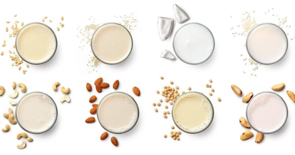 Set or collection of various vegan milk (almond, soy, rice, coconut, quinoja, brazil nut, cashew, oat) isolated on white background, top view. Dairy free, plant based drink.