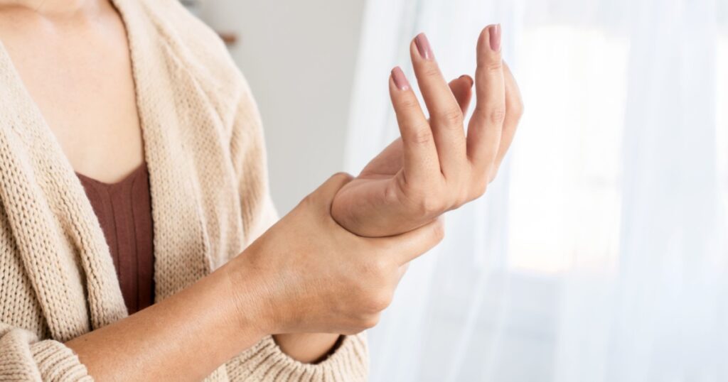 woman suffering from wrist pain, numbness, or Carpal tunnel syndrome hand holding her ache joint