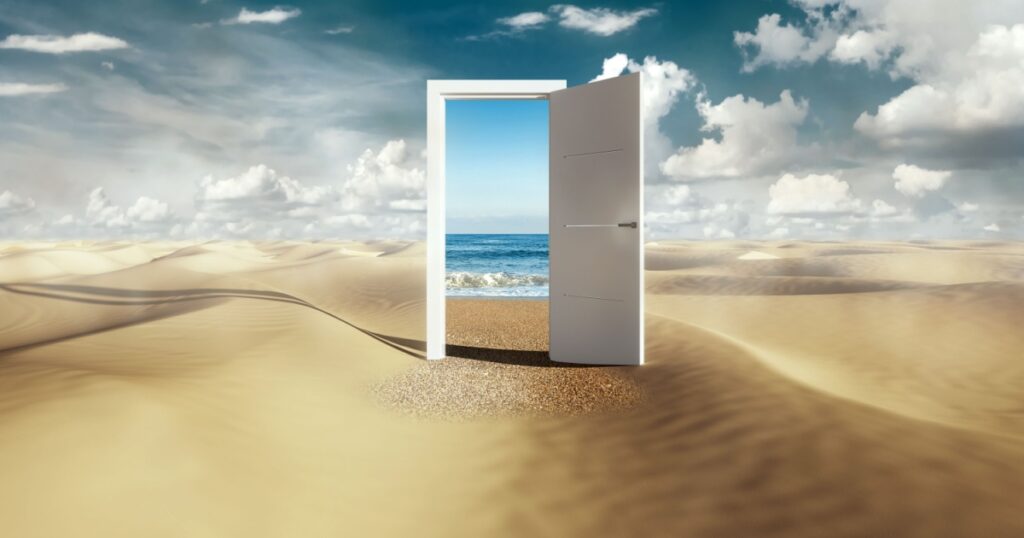 Open door with access to the beach from desert. Travel concept.