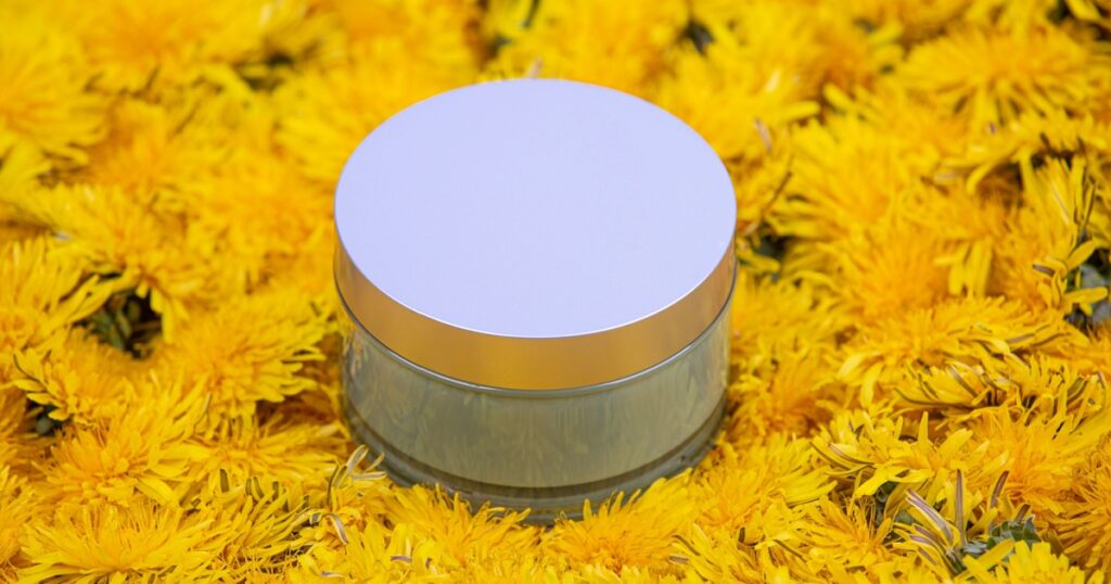A jar lying in dandelion flowers, close-up