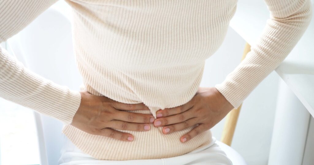 Woman with stomach pain causes of abdominal pain include inflammatory bowel disease-IBD. stomach ulcer irritable bowel syndrome (IBS), ulcerative colitis and microvilli. closeup photo, blurred.