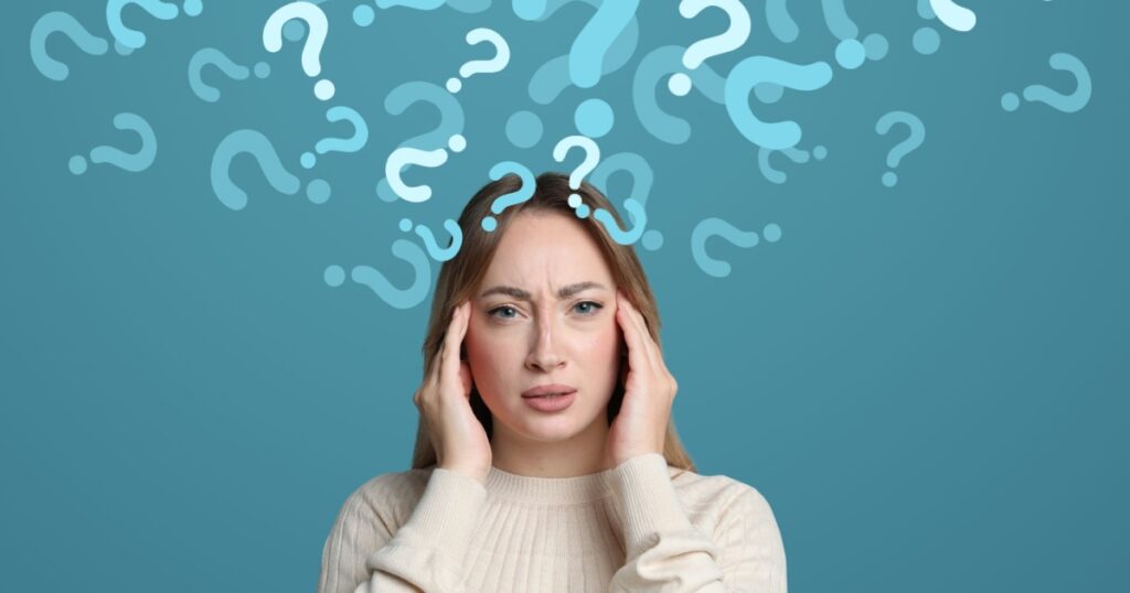 Amnesia concept. Woman trying to remember something on color background. Flow of question marks symbolizing memory loss