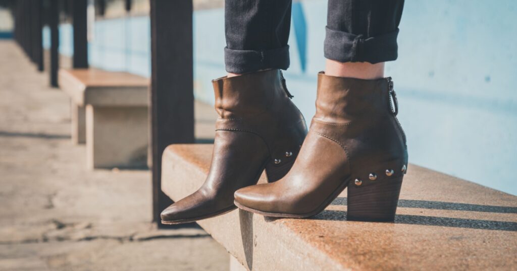 Detail of ankle boots on bench in a metro station
