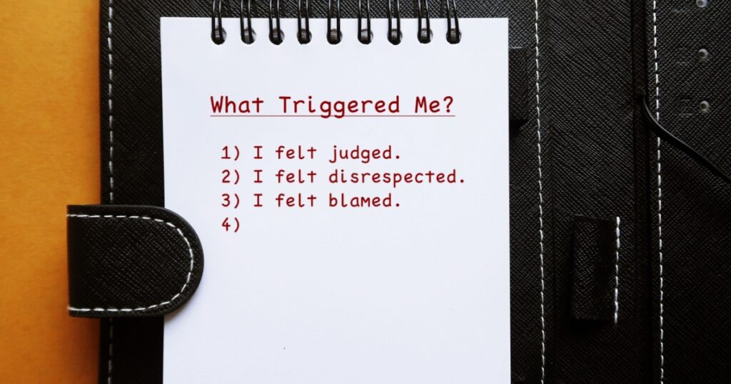 Notebook with handwritten text WHAT TRIGGERED ME? with list of Identify what triggerred or escalated the interaction in you to figure out how to make it better