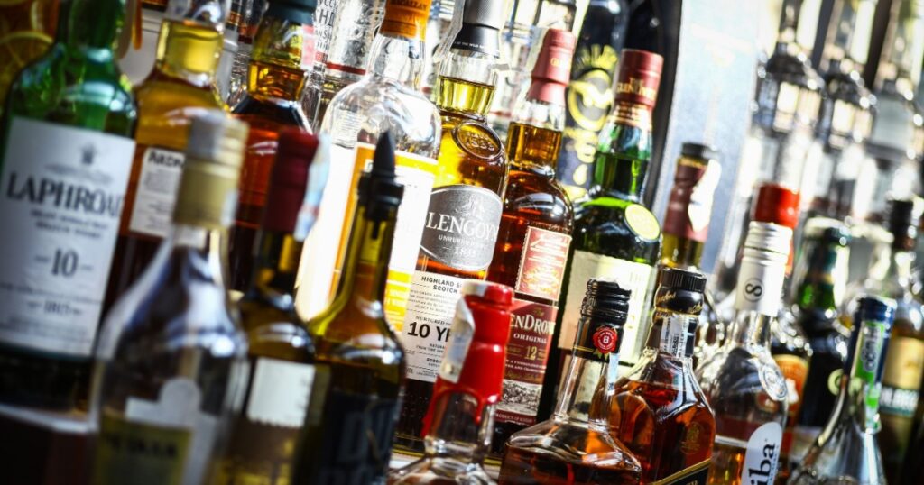 Bucharest, Romania - September 9, 2015: Several types of bottled alcohol are displayed on some shelves in a pub in Bucharest, Romania.