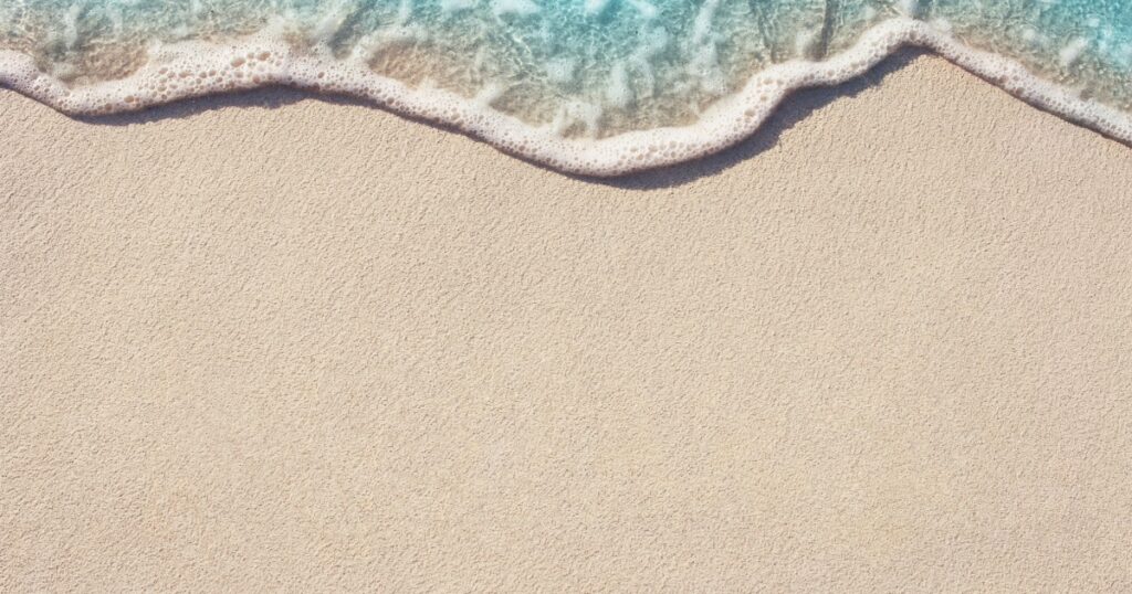 Soft Wave Of Blue Ocean On Sandy Beach. Background. Selective focus.