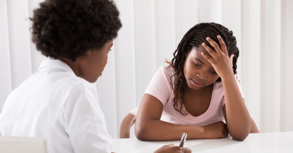 Portrait Of Female Doctor Comforting Depressed Patient
