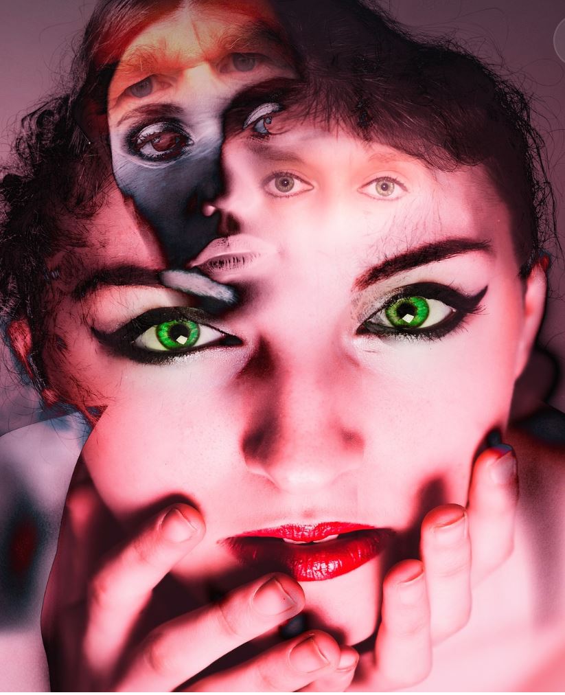 Distorted close up of a woman with green eyes.
