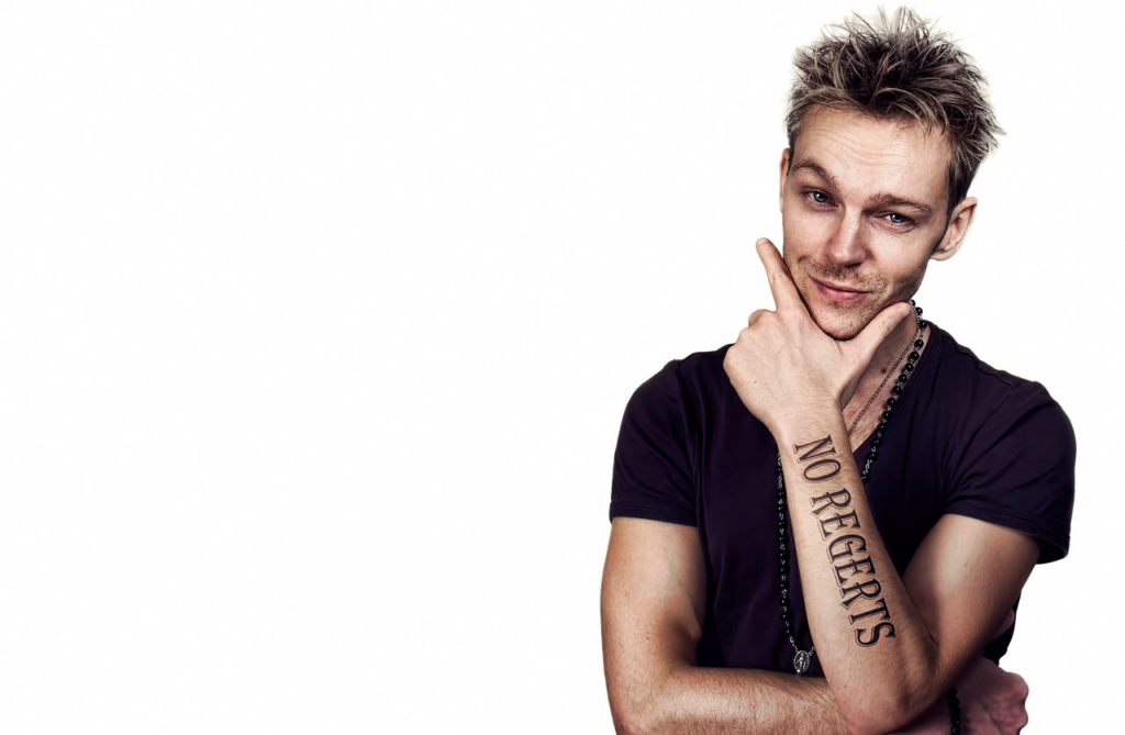 man with no regrets tattoo on his arm