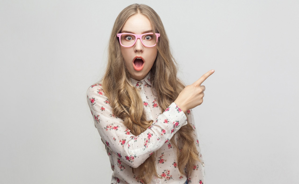 shocked woman pointing to her left