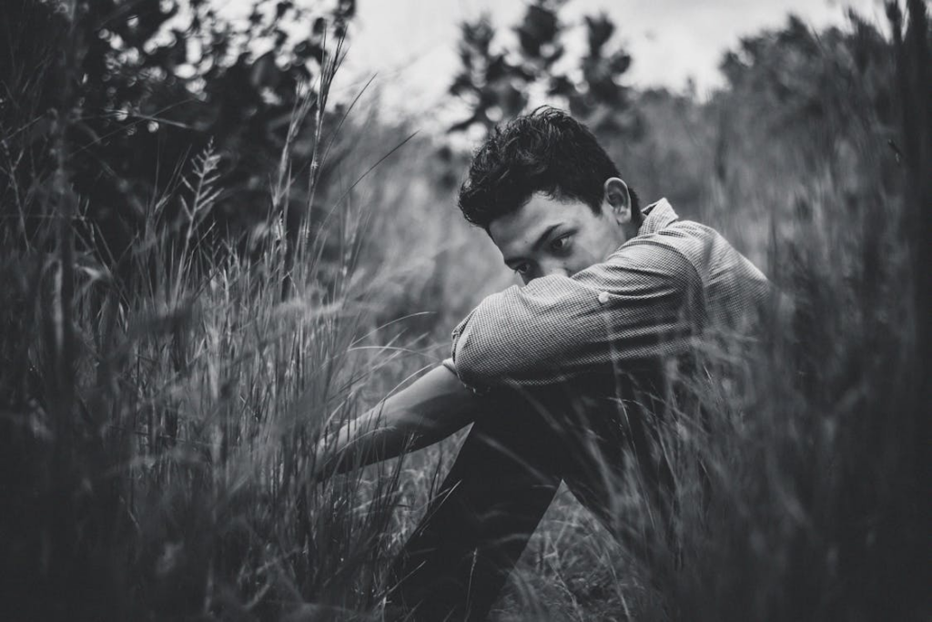 Depressed man in long grass