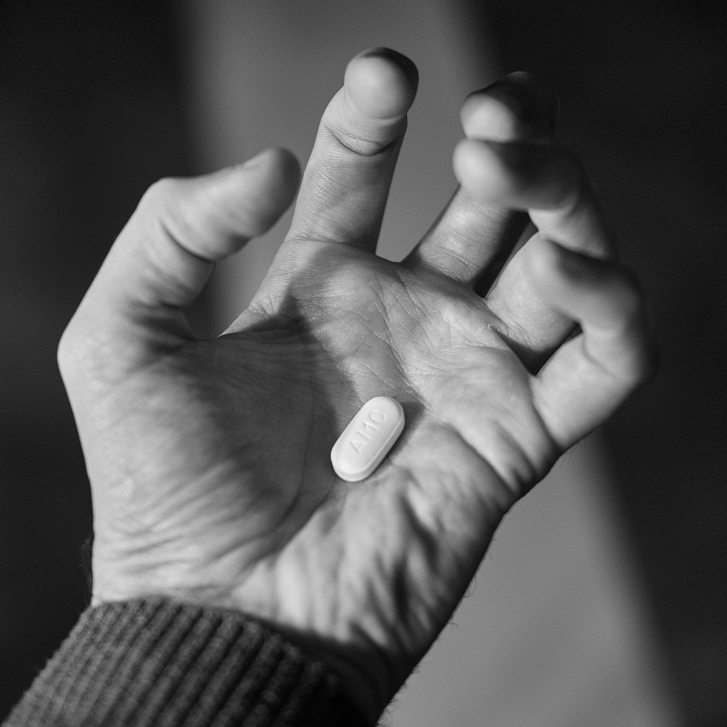 hand in a claw shape holding penicillin