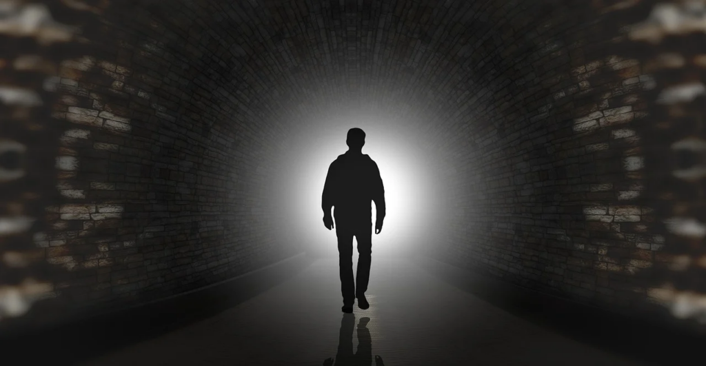 man walking to light
