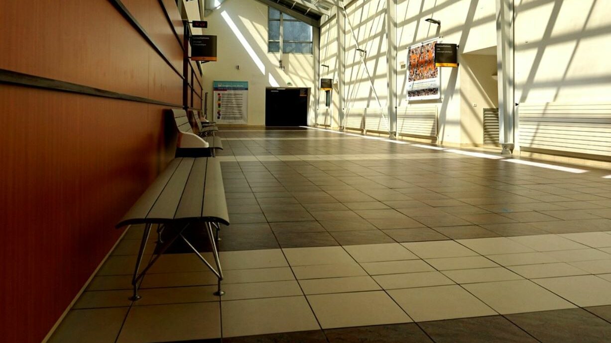 Hospital ward hallway. Sunlight shining in through windows.