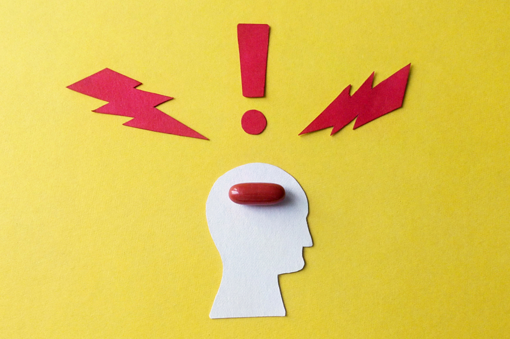 Cardboard image of the person who took the brain medicine from paper on a yellow background the effect of the drug on health