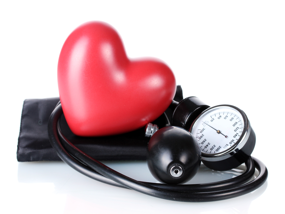 Black tonometer and heart isolated on white