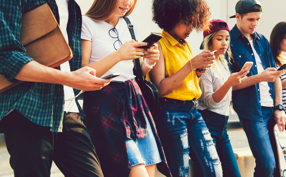 Diverse friends using their phones