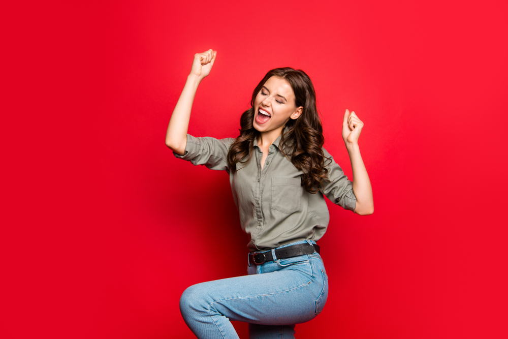 Achievement concept. Profile side view photo of gorgeous, good-looking person in casual shirt raised fists, eyes close up isolated on shine red background