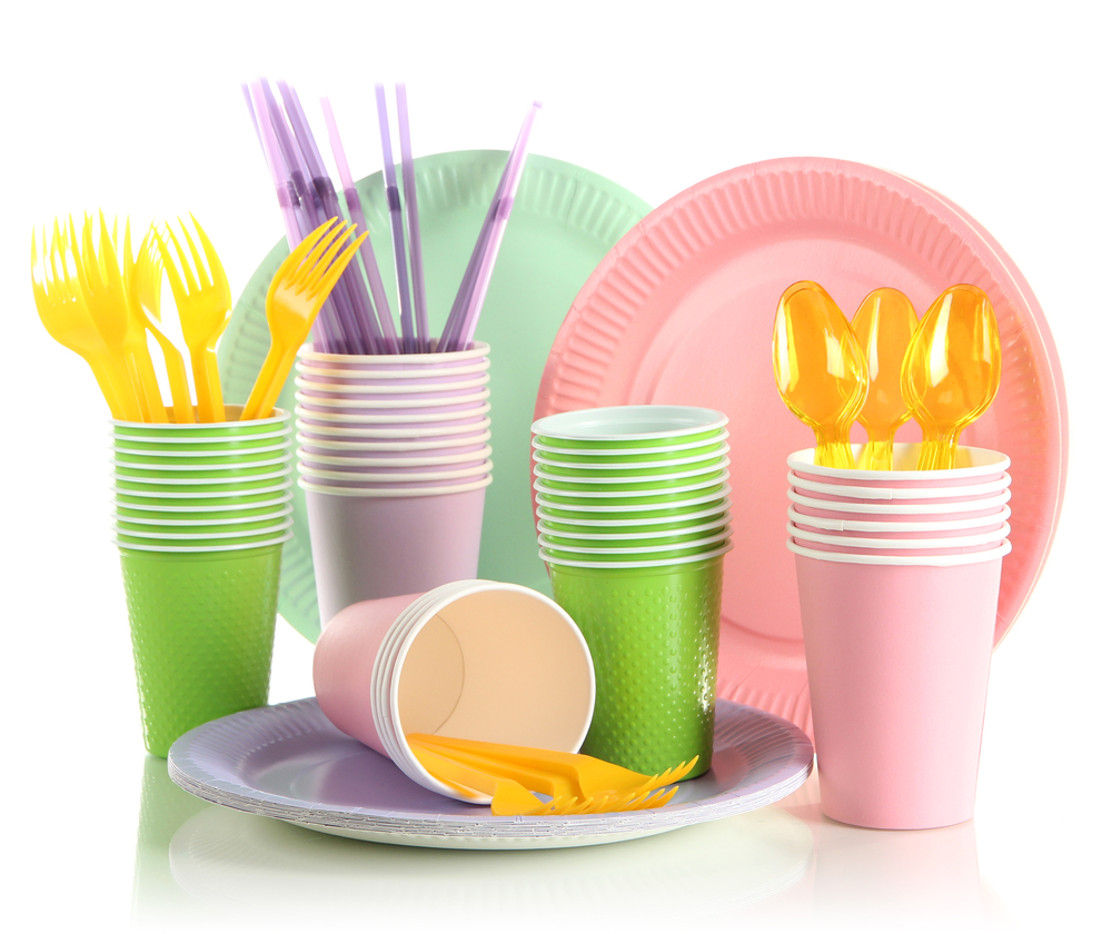 Multicolored plastic tableware isolated on white