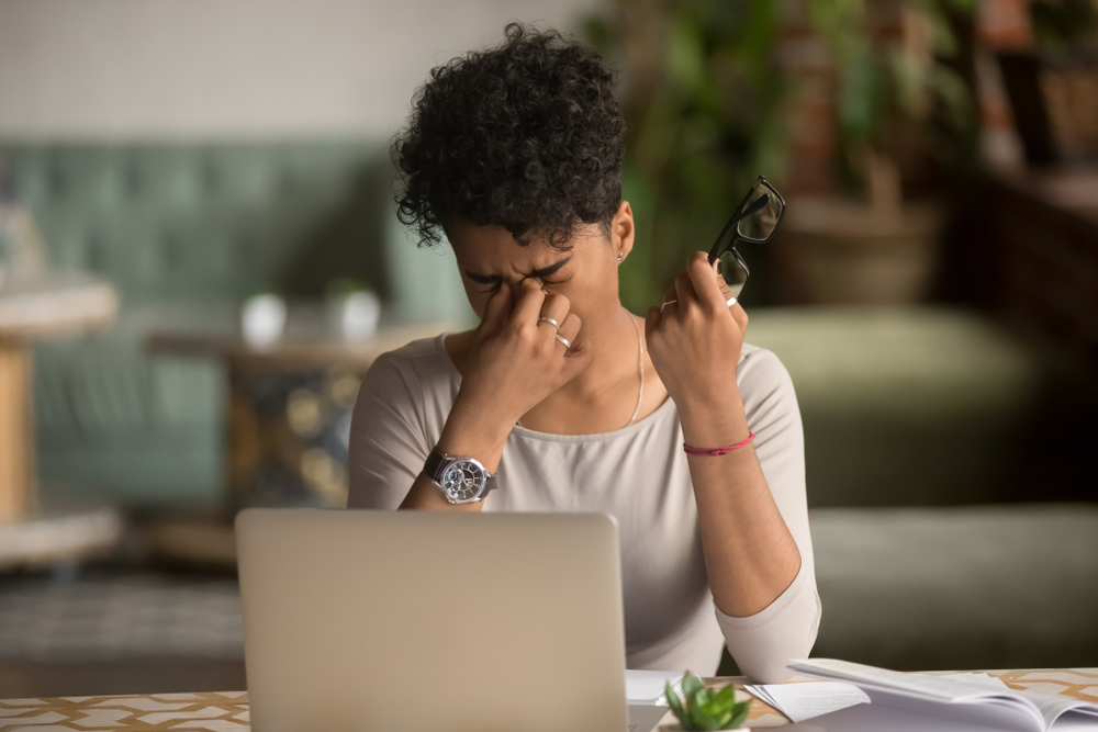 Overworked tired african female student worker holding glasses feel eye strain fatigue after computer work, mixed race woman suffer from pain in dry irritated eyes, bad blurry vision eyesight problem
