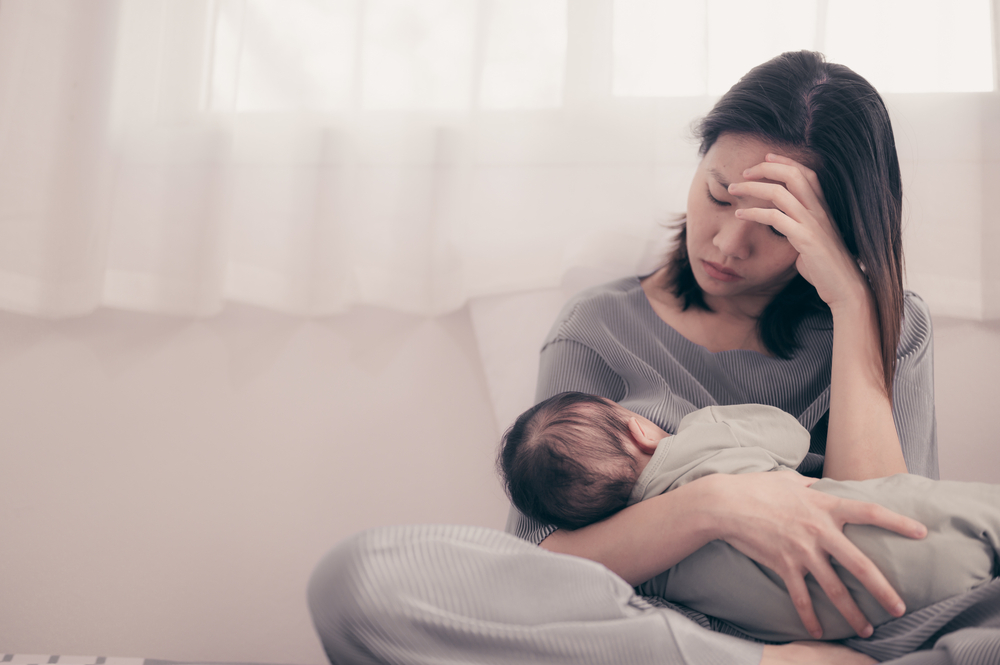 Tired Mother Suffering from experiencing postnatal depression.Health care single mom motherhood stressful.