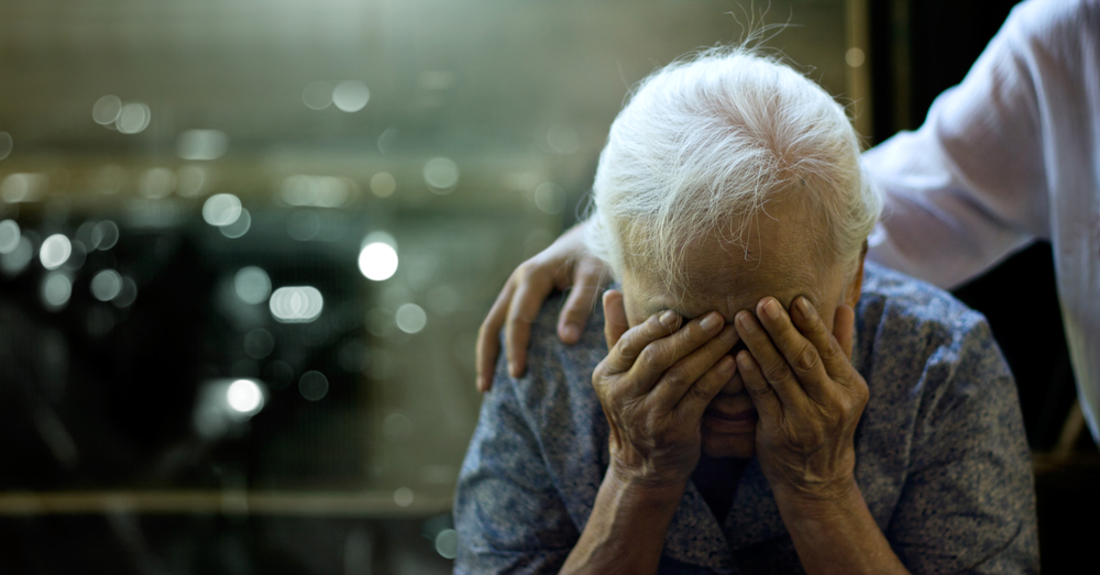 The daughter is comforting an elderly woman who is a mother sadness with Alzheimer's disease and amnesia, Memory loss due to dementia.