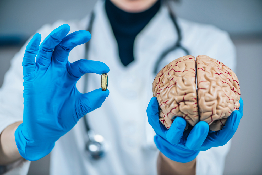 Placebo Effect Concept. Female doctor holding model of brain and placebo supplement pill, explaining the placebo effect healing phenomenon