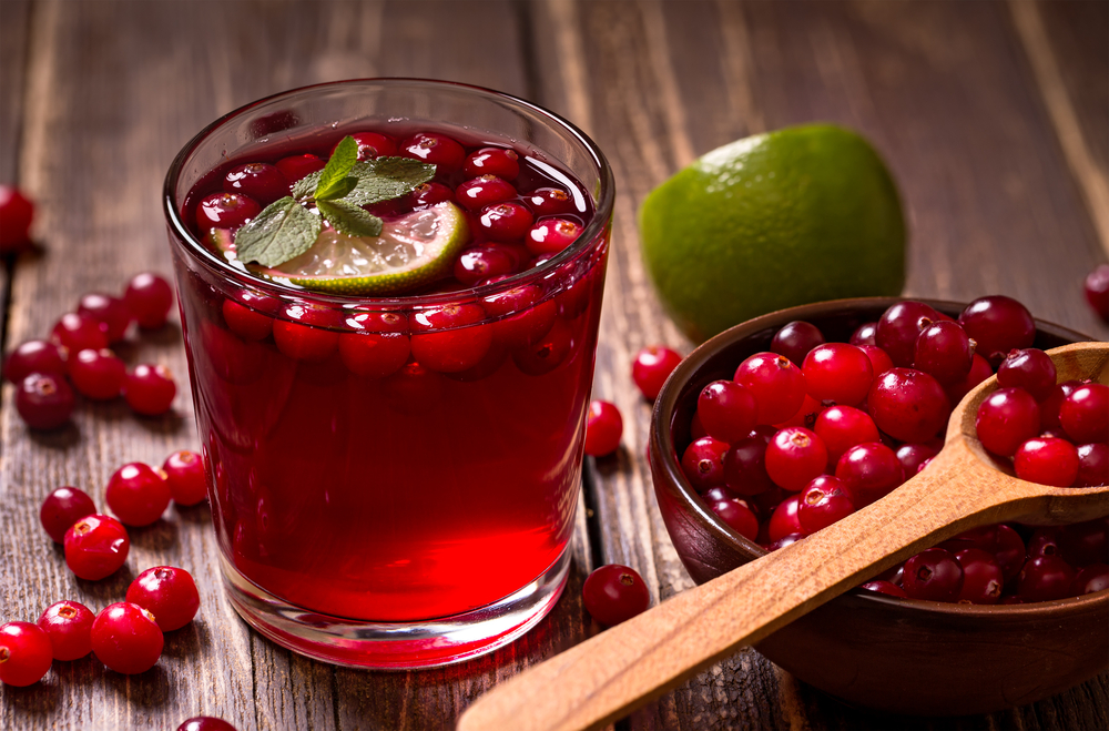 Fresh cranberry drink on wooden background