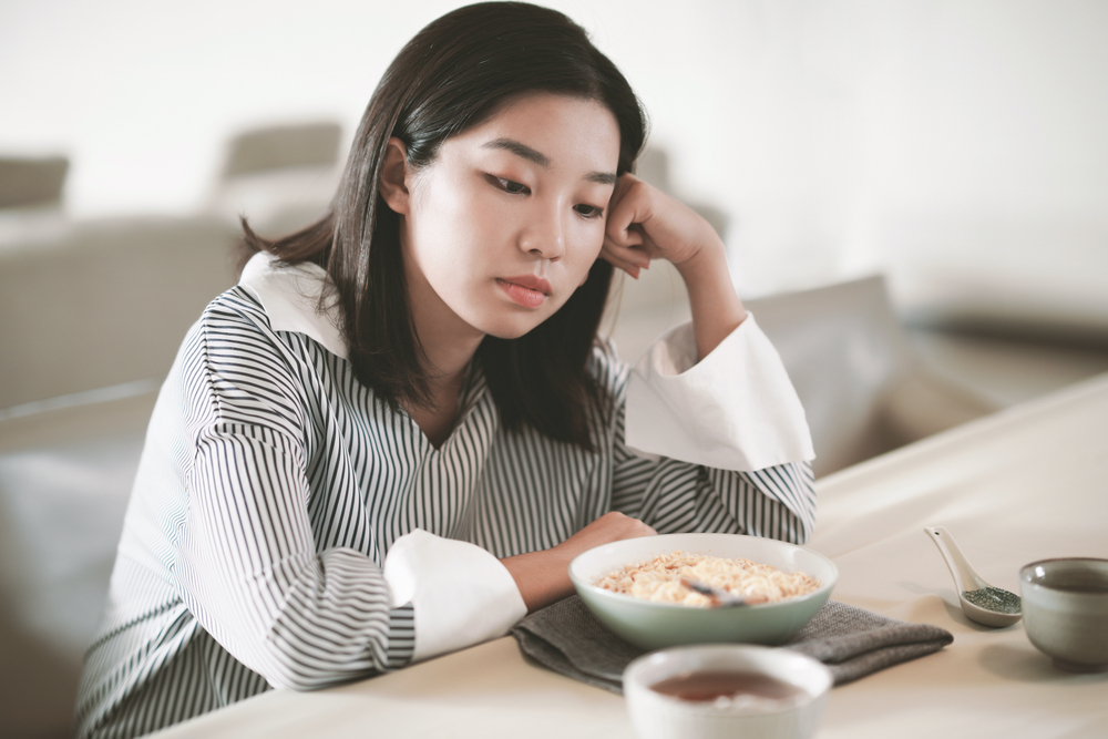 Asian young woman eating food