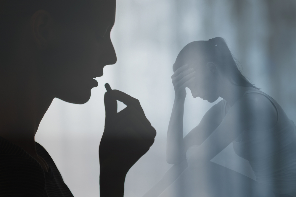 Woman swallowing medication pill. People drug addiction, sickness and mental depression concept.